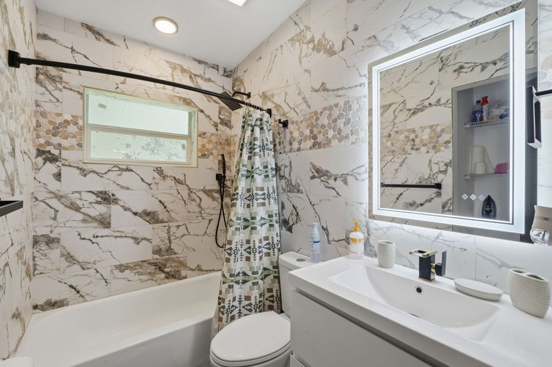 Second bathroom with tub and shower