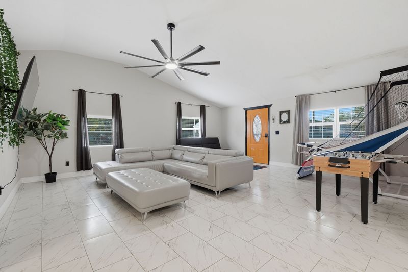 Living room with game area and front door