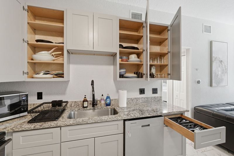 Kitchen counter and stocked cabinets