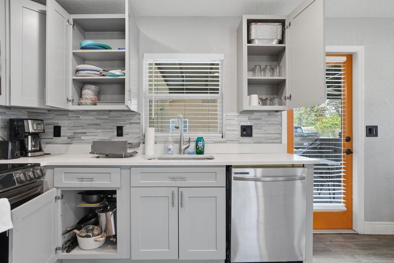 Kitchen cabinets stocked with dishes and cookware
