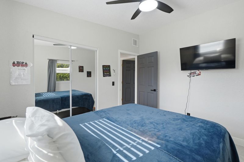 Bedroom with wall-mounted TV