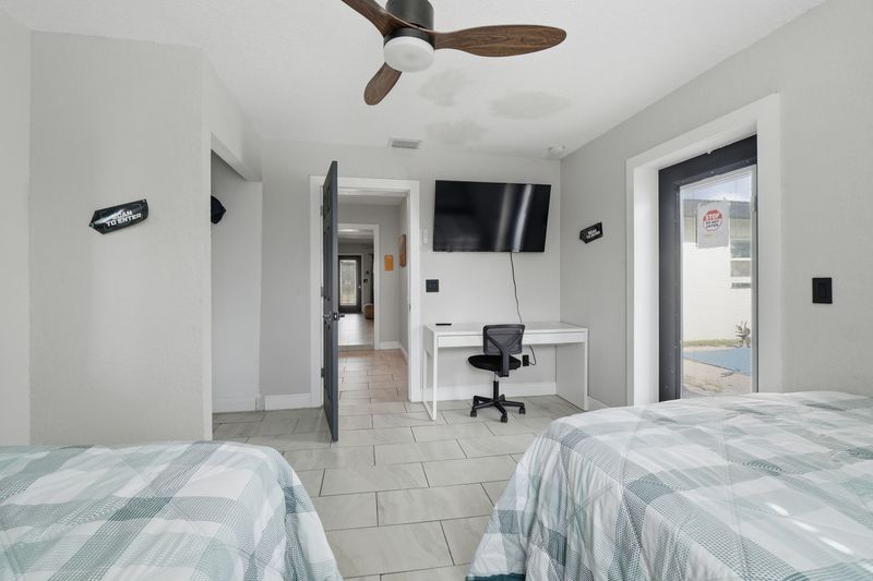 Bedroom with two beds and a work desk